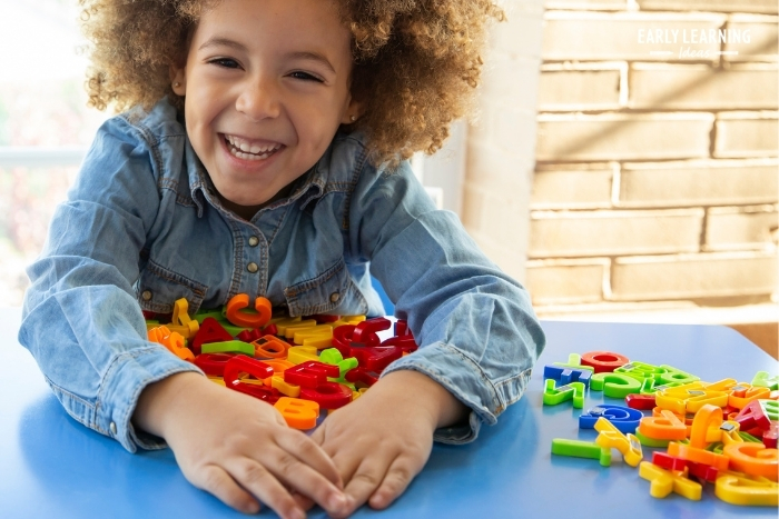 Child practicing multi-sensory phonics learning with tactile letters